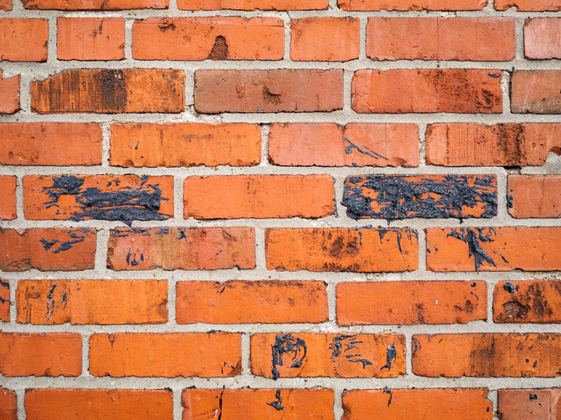 Square red orange brick wall horizontal abstract background with black tar pattern